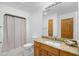 Bathroom with a sink, toilet, shower with curtain and large mirror at 1043 Yellow Jasmine Dr., Longs, SC 29568
