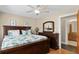 A cozy bedroom features a large bed, a window, and a ceiling fan at 1043 Yellow Jasmine Dr., Longs, SC 29568