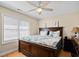Comfortable bedroom with a window, ceiling fan, and large bed at 1043 Yellow Jasmine Dr., Longs, SC 29568