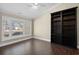 Relaxing bedroom with wood floors, a large window, and custom built-in shelving at 1043 Yellow Jasmine Dr., Longs, SC 29568