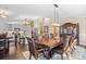 Elegant dining room showcasing a large wood table, ornate details, and an adjacent modern kitchen at 1043 Yellow Jasmine Dr., Longs, SC 29568