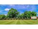 Well-maintained entrance to Long Bay Club with manicured lawn, brick wall, and lush greenery at 1043 Yellow Jasmine Dr., Longs, SC 29568