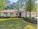 Attractive home with manicured landscaping, garden beds, and two-car garage, creating an appealing exterior at 1043 Yellow Jasmine Dr., Longs, SC 29568