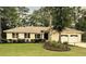 Beautiful house boasts well-kept lawn, flowerbeds, and two-car garage adding to its curb appeal at 1043 Yellow Jasmine Dr., Longs, SC 29568