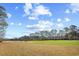 Golf course with blue skies, trees, and well-manicured green grass at 1043 Yellow Jasmine Dr., Longs, SC 29568