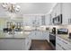 Bright kitchen features white cabinetry, modern appliances, and granite countertops at 1043 Yellow Jasmine Dr., Longs, SC 29568