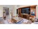 Elegant living area featuring wood floors, a large entertainment center, and bright natural light at 1043 Yellow Jasmine Dr., Longs, SC 29568
