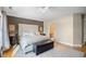 Comfortable main bedroom featuring a large window, wood floors, and a decorative headboard at 1043 Yellow Jasmine Dr., Longs, SC 29568