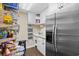 Well-organized pantry with shelving, ample storage, and a stainless-steel refrigerator at 1043 Yellow Jasmine Dr., Longs, SC 29568