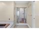 Open glass shower enclosure with decorative tile walls, bench, and chrome hardware at 1043 Yellow Jasmine Dr., Longs, SC 29568