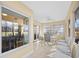 Bright sunroom with tile floors, ceiling fan, and views of the golf course at 1043 Yellow Jasmine Dr., Longs, SC 29568