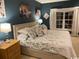 Elegant bedroom with dark walls, bright window, and floral patterned bedding at 1101 Louise Costin Ln. # 1308, Murrells Inlet, SC 29576