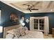 Elegant bedroom with dark walls, bright window, and floral patterned bedding at 1101 Louise Costin Ln. # 1308, Murrells Inlet, SC 29576