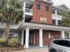A sunny view of this condo building showcasing lovely architectural detail, palm trees and brick at 1101 Louise Costin Ln. # 1308, Murrells Inlet, SC 29576