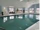 Spacious indoor swimming pool with large windows allowing natural light and comfortable seating at 1101 Louise Costin Ln. # 1308, Murrells Inlet, SC 29576