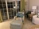 Comfortable living room with large sliding glass doors, neutral carpet and chair with ottoman at 1101 Louise Costin Ln. # 1308, Murrells Inlet, SC 29576