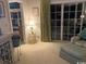 Living room featuring large sliding glass doors, neutral carpet and comfortable chair with ottoman at 1101 Louise Costin Ln. # 1308, Murrells Inlet, SC 29576
