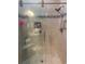Beautiful tiled shower featuring a glass door, corner seat, and tiled niche for toiletries at 1101 Louise Costin Ln. # 1308, Murrells Inlet, SC 29576