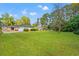 Large backyard with mature trees and well-maintained lawn at 115 Carolina Ave., Mullins, SC 29574