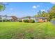 Backyard view with well-manicured lawn and view of neighboring houses at 115 Carolina Ave., Mullins, SC 29574