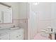 Bathroom featuring a vanity, sink, toilet, shower and retro floral wallpaper at 115 Carolina Ave., Mullins, SC 29574