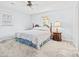 Bright bedroom with ceiling fan, natural light, and decorative wooden headboard at 115 Carolina Ave., Mullins, SC 29574