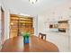 Open-concept dining room with wood table and chairs, built-in shelving and kitchen access at 115 Carolina Ave., Mullins, SC 29574