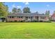 Charming brick ranch home with a well-maintained lawn and landscaping at 115 Carolina Ave., Mullins, SC 29574
