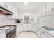 Classic white kitchen featuring ample cabinet space and marble-patterned countertops at 115 Carolina Ave., Mullins, SC 29574