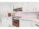 Cozy kitchen features a range and dishwasher beneath marble-esque countertops at 115 Carolina Ave., Mullins, SC 29574