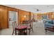 Open living area with wood paneling, a classic rug, and multiple seating arrangements at 115 Carolina Ave., Mullins, SC 29574