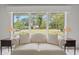 Bright living room with a large window view, neutral couch, and stylish side tables at 115 Carolina Ave., Mullins, SC 29574