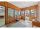 Enclosed sunroom featuring multiple windows and access to the garage at 115 Carolina Ave., Mullins, SC 29574