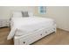 Bright bedroom featuring a bed with drawers, white linens, light wood furniture, and a window providing ample natural light at 1211-B N Waccamaw Dr., Garden City Beach, SC 29576