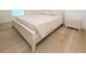 Bedroom featuring a bed with a white comforter and side table at 1211-B N Waccamaw Dr., Garden City Beach, SC 29576