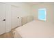 Comfortable bedroom features a soft bed and light hardwood floors and natural light at 1211-B N Waccamaw Dr., Garden City Beach, SC 29576