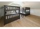 Spacious bedroom with three bunk beds and light wood flooring, perfect for or guests at 1211-B N Waccamaw Dr., Garden City Beach, SC 29576