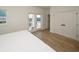 Bright bedroom featuring a private outdoor balcony with sliding glass doors and a closet at 1211-B N Waccamaw Dr., Garden City Beach, SC 29576