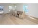 Formal dining area featuring hardwood floors, a large table, and bright windows at 1211-B N Waccamaw Dr., Garden City Beach, SC 29576