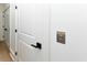 Modern hallway featuring white doors with black handles and a call button at 1211-B N Waccamaw Dr., Garden City Beach, SC 29576