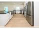 Bright kitchen with stainless steel appliances, white cabinets, and a farmhouse sink at 1211-B N Waccamaw Dr., Garden City Beach, SC 29576