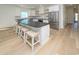 Bright kitchen with breakfast bar, stainless steel appliances, open shelving and hardwood floors at 1211-B N Waccamaw Dr., Garden City Beach, SC 29576