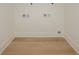 Empty laundry room featuring wood-look flooring, white trim, and washer and dryer hookups at 1211-B N Waccamaw Dr., Garden City Beach, SC 29576