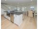 Open living area featuring hardwood floors, kitchen island, stairs, and dining area at 1211-B N Waccamaw Dr., Garden City Beach, SC 29576