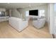 Spacious living room with stylish seating, hardwood floors, and access to the kitchen at 1211-B N Waccamaw Dr., Garden City Beach, SC 29576