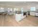 Open concept living space with hardwood floors, island seating and access to the dining area at 1211-B N Waccamaw Dr., Garden City Beach, SC 29576