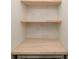 View of shelving unit inside pantry with white tile back splash and an electrical outlet at 1211-B N Waccamaw Dr., Garden City Beach, SC 29576
