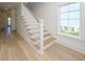 Elegant staircase with hardwood treads, white risers and natural light at 1211-B N Waccamaw Dr., Garden City Beach, SC 29576