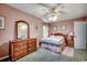 Bedroom featuring a ceiling fan, wood furnishings, light pink walls, and a window at 1300 Anderson St., Conway, SC 29526