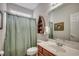 Bathroom with a boat shelf, and shower with striped curtain at 1411 Powhaton Dr., Myrtle Beach, SC 29577